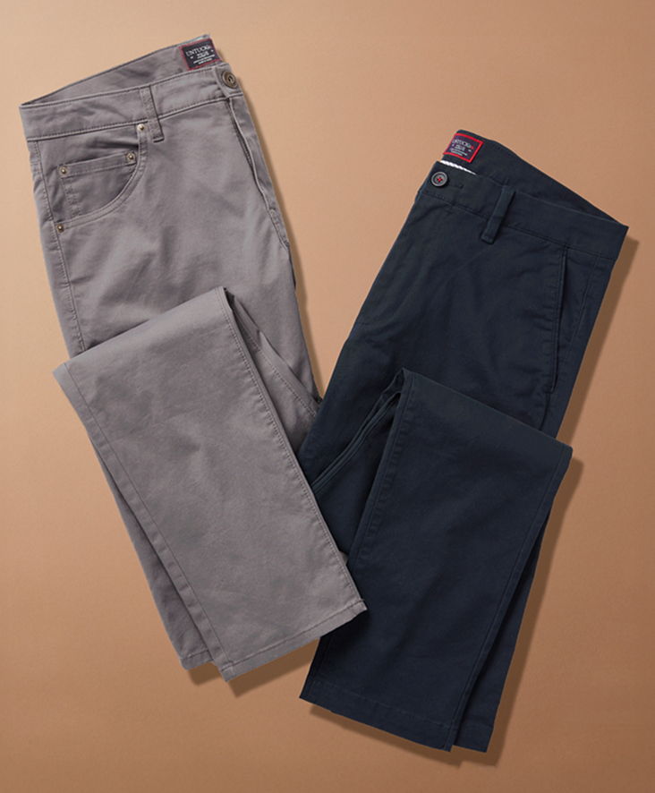 Two pairs of pants in gray and navy on a beige background.