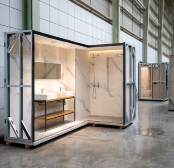 Modern bathroom display in a spacious industrial setting.