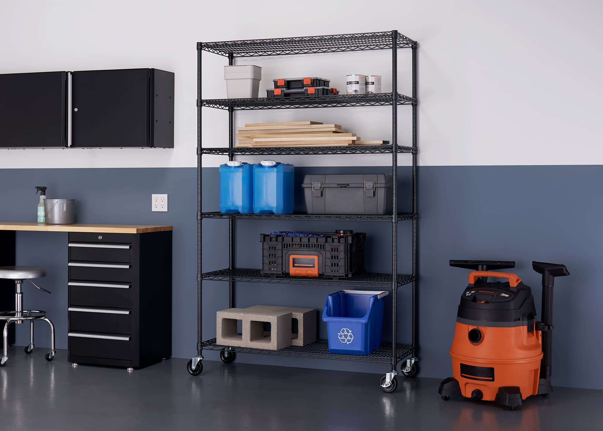 tall garage wire shelving rack filled with wood working supplies and tool boxes