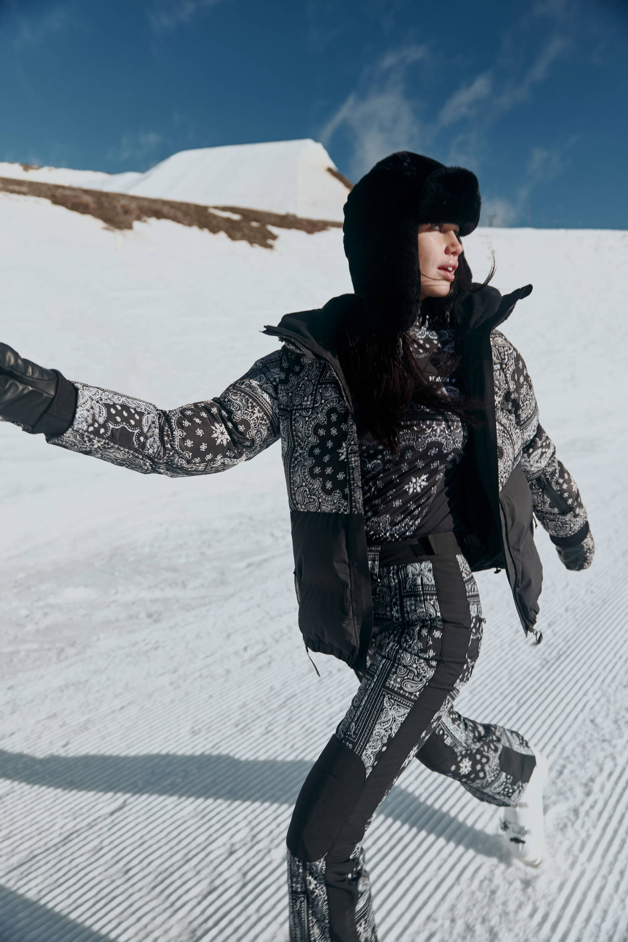 Girl walking on ski slopes wearing ski gear