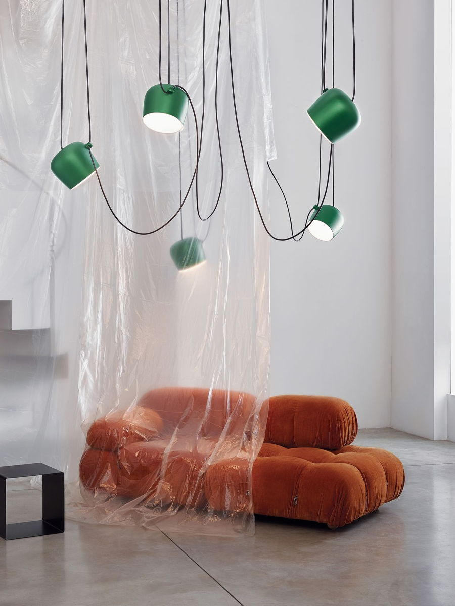 Modern interior with orange Camaleonda Sofa by B&B Italia and green Aim pendant lights by Flos.