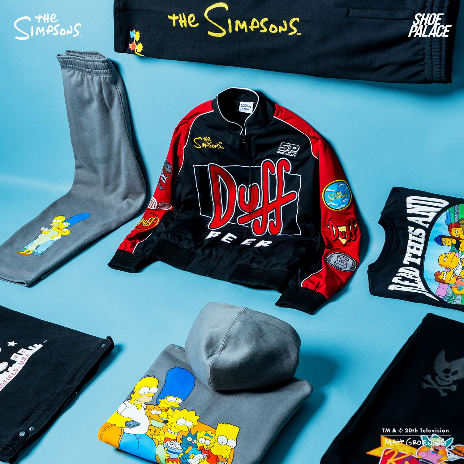 The Simpsons themed clothing laid out on a blue background.