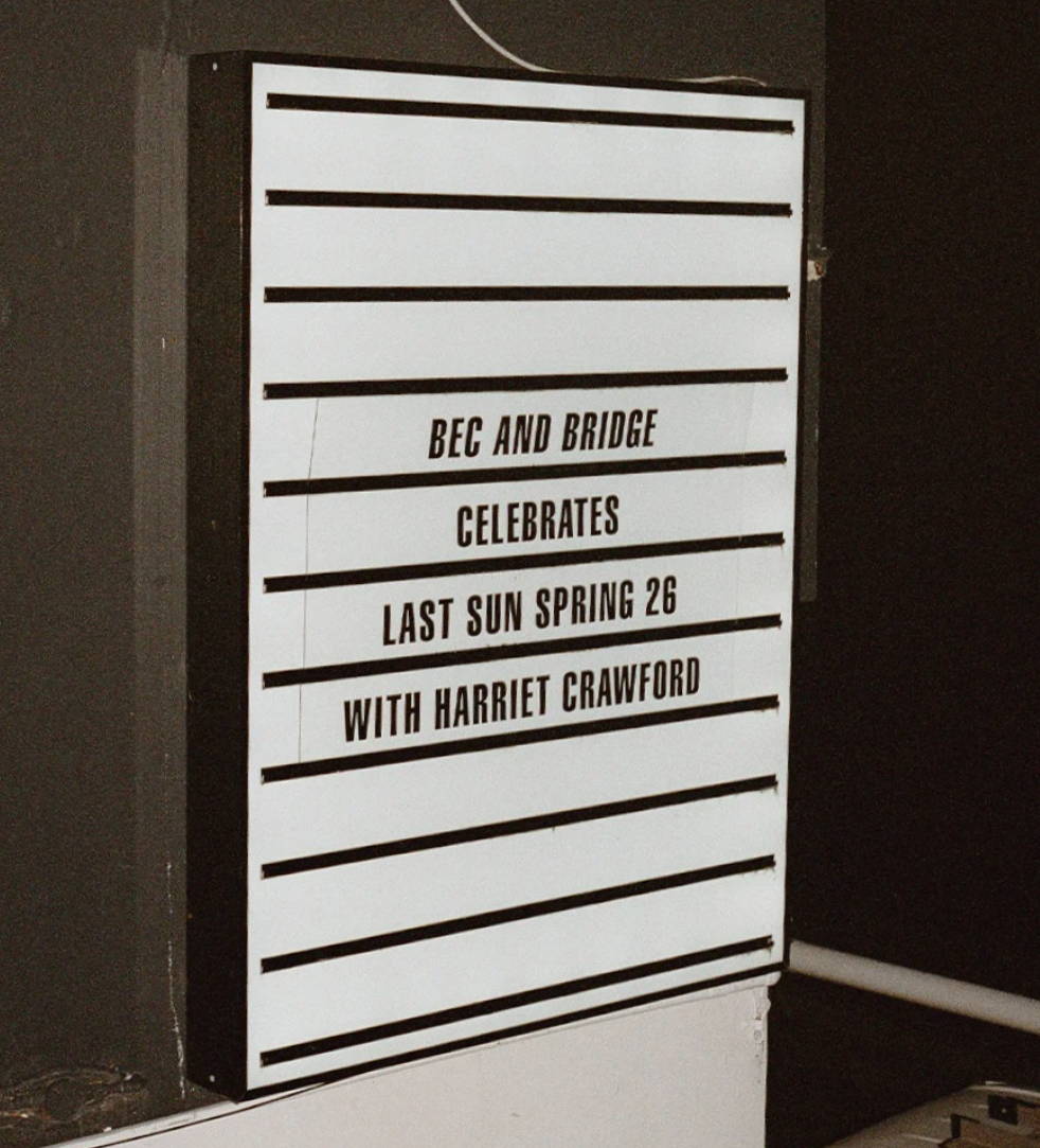 Sign announcing event with Harriet Crawford on Last Sun Spring 26.