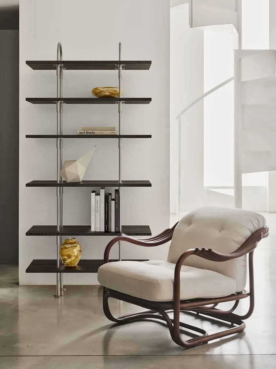 Modern interior featuring a wooden chair and a minimalist shelving unit.