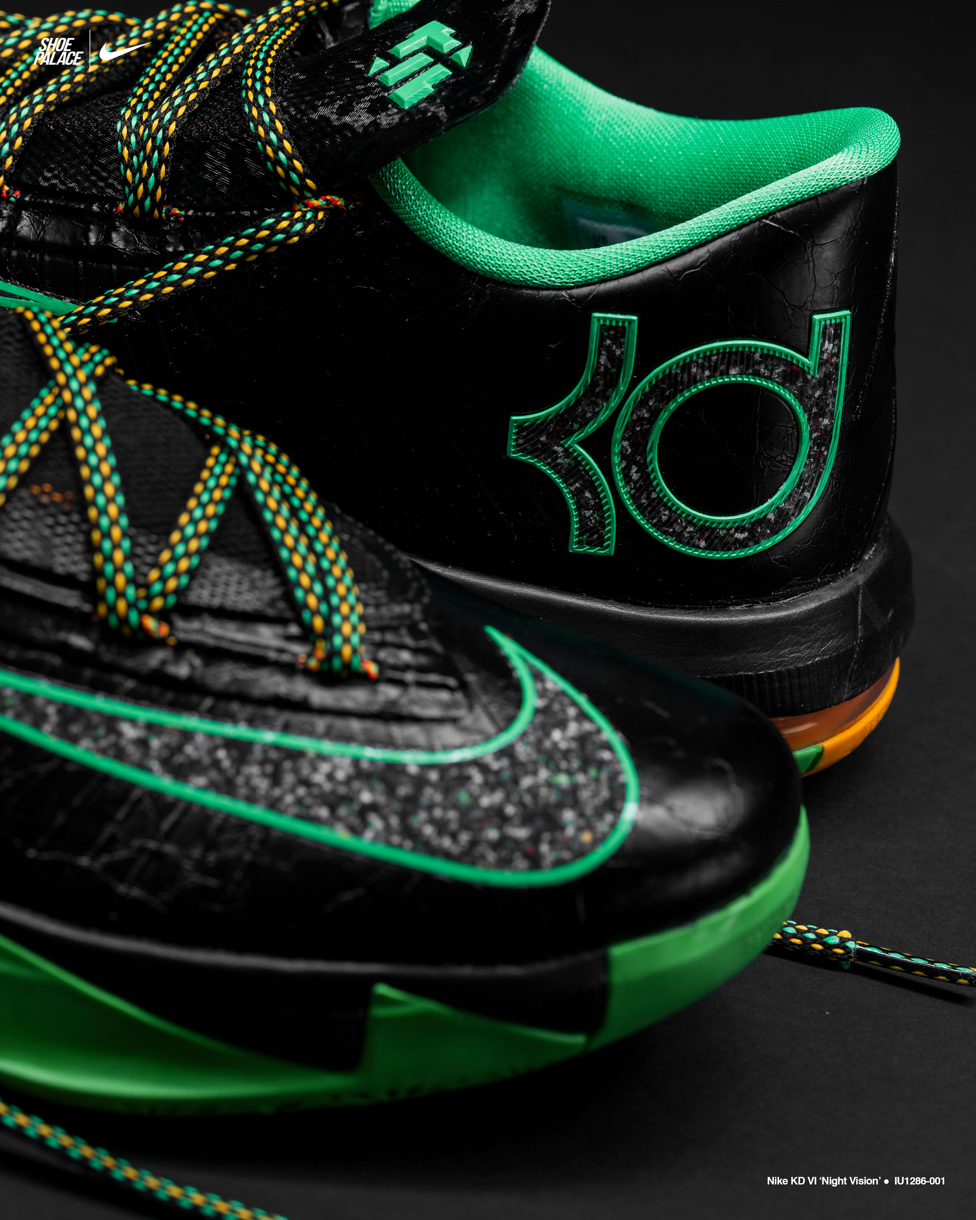 Black and green athletic shoes with unique laces and logo detail.