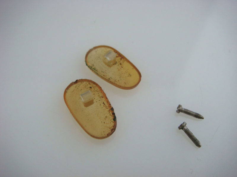 Old dirty yellow nose pads and their screws