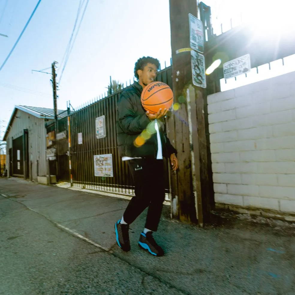 male model wearing aj13 university blue w basketball