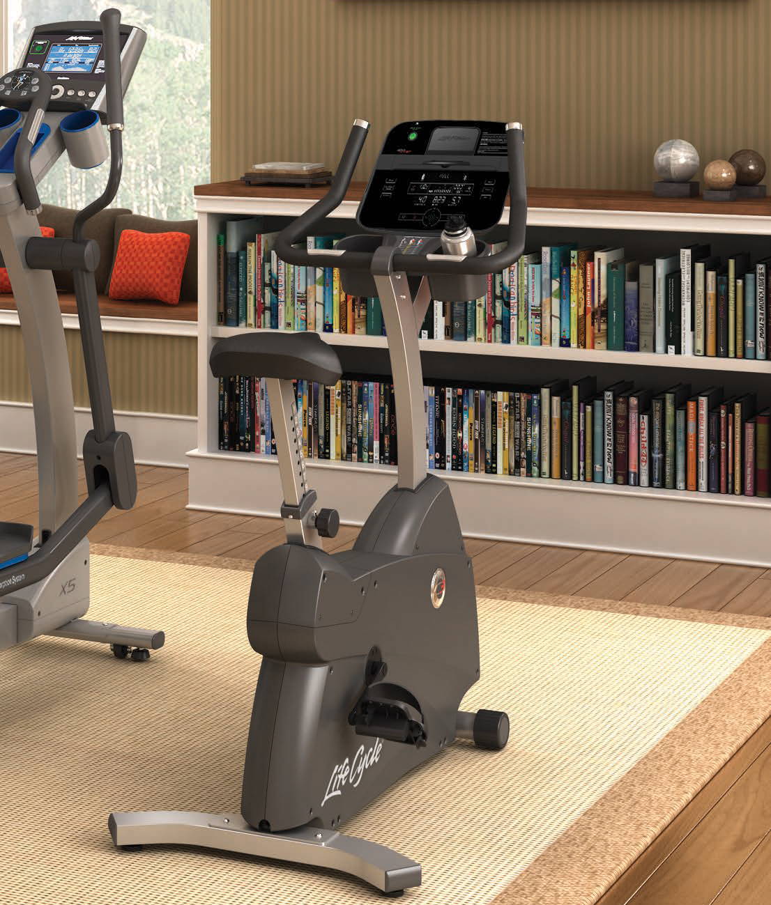 C3 Lifecycle exercise bike next to other fitness equipment in home