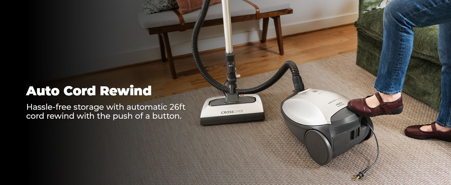 Vacuum cleaner with auto cord rewind feature and person using it.