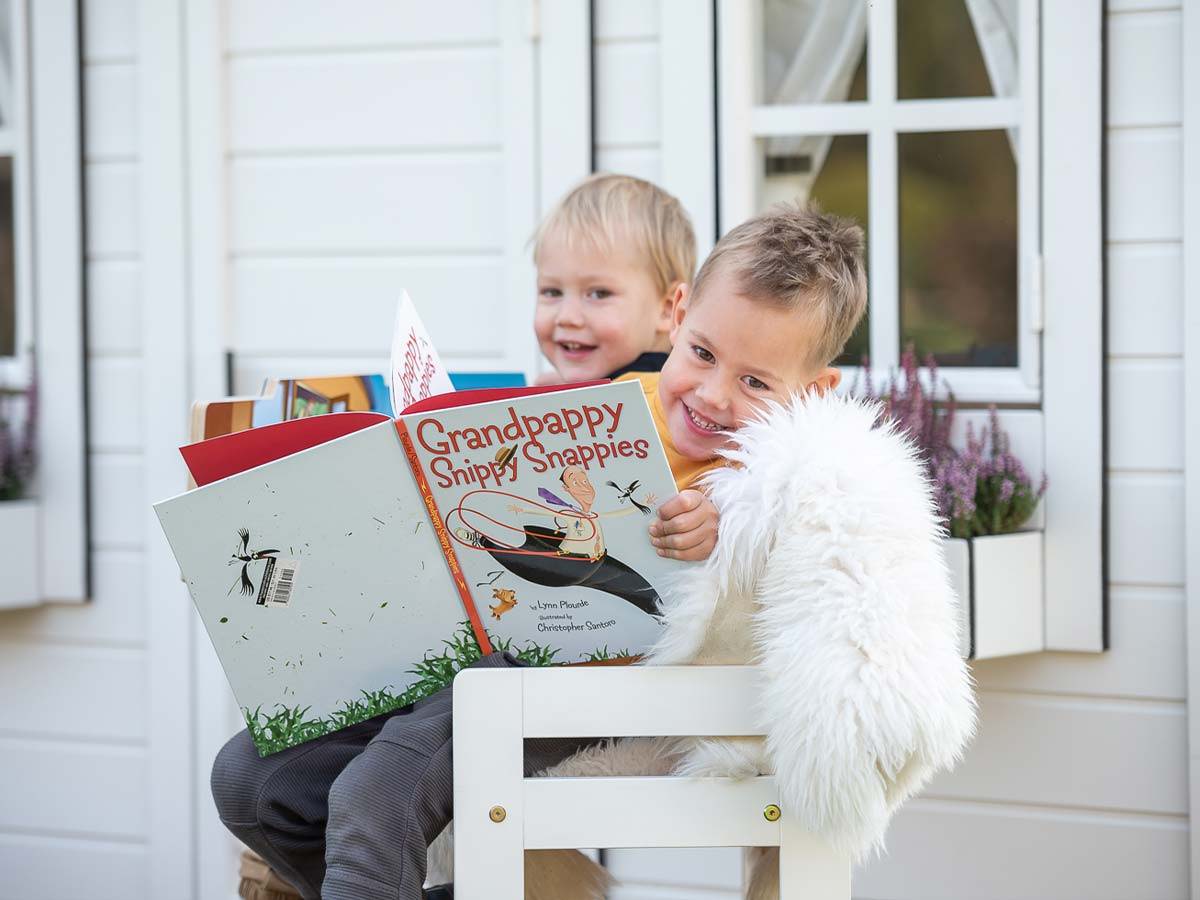 Kids playing on the porch of Kids Playhouse Arctic Nario by WholeWoodPlayhouses