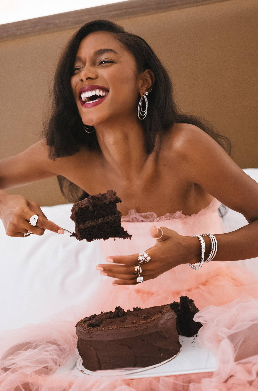 Model wearing Ring Concierge jewelry eating cake