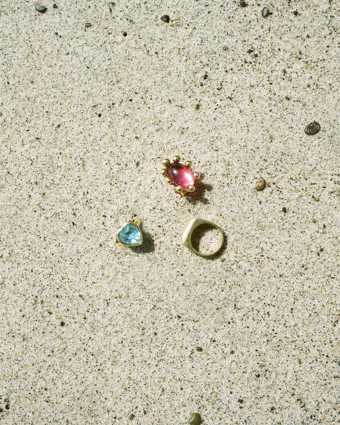 Mondo Mondo jewelry laying on the beach.