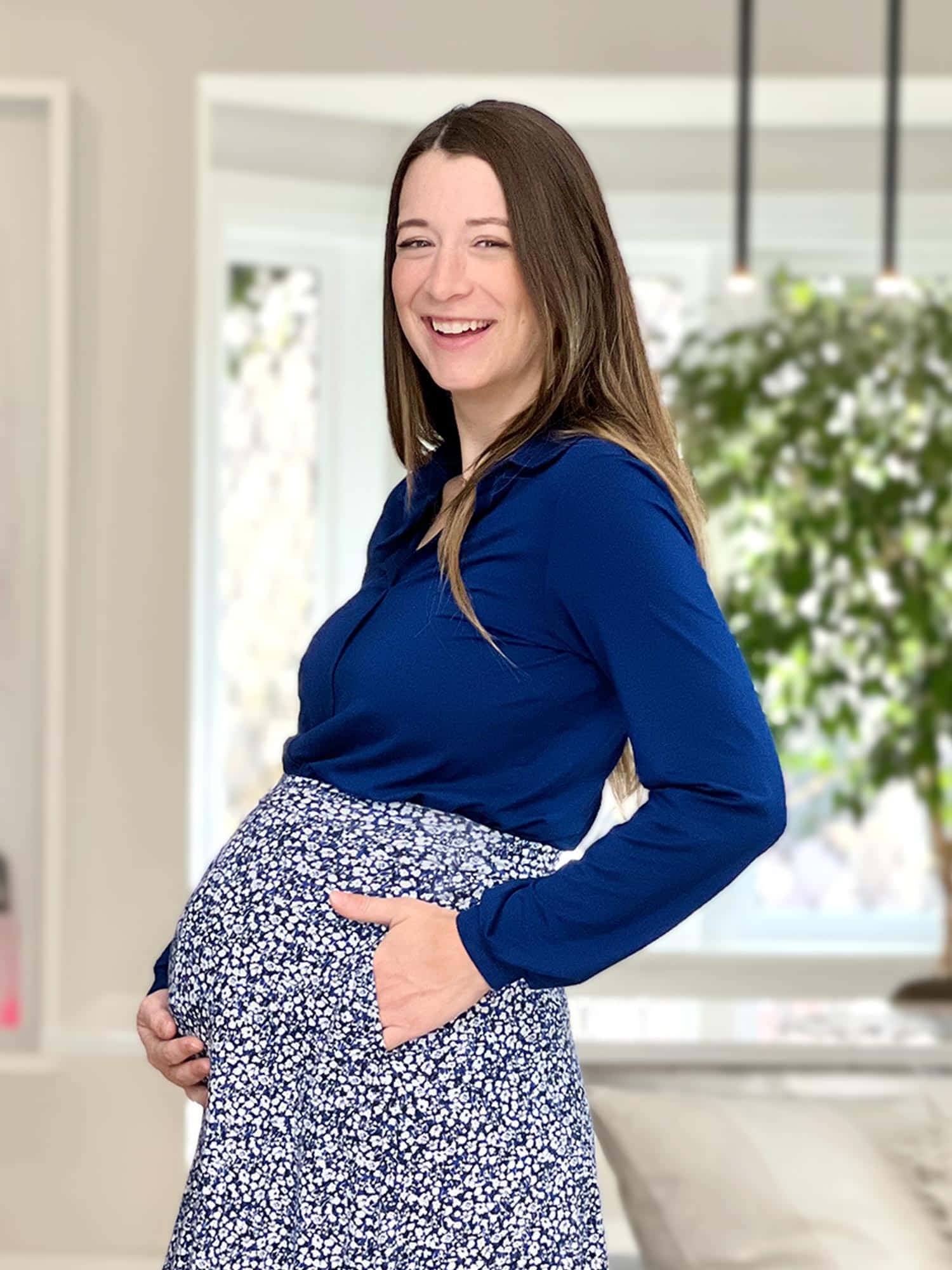 Pregnant woman wearing Miik's Lucia collared shirt in royal blue with a skirt