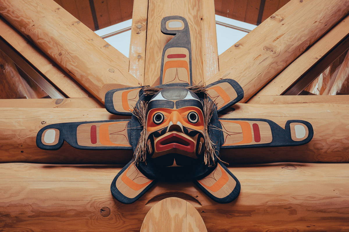 A First Nation carving of a face hanging above a doorway