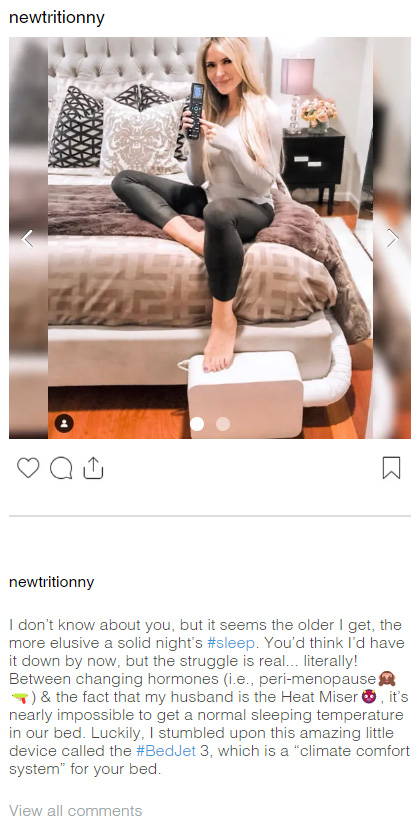 Instagram post by @newtritionny of a blonde woman sitting on the edge of a bed showing off her BedJet 3 and remote control