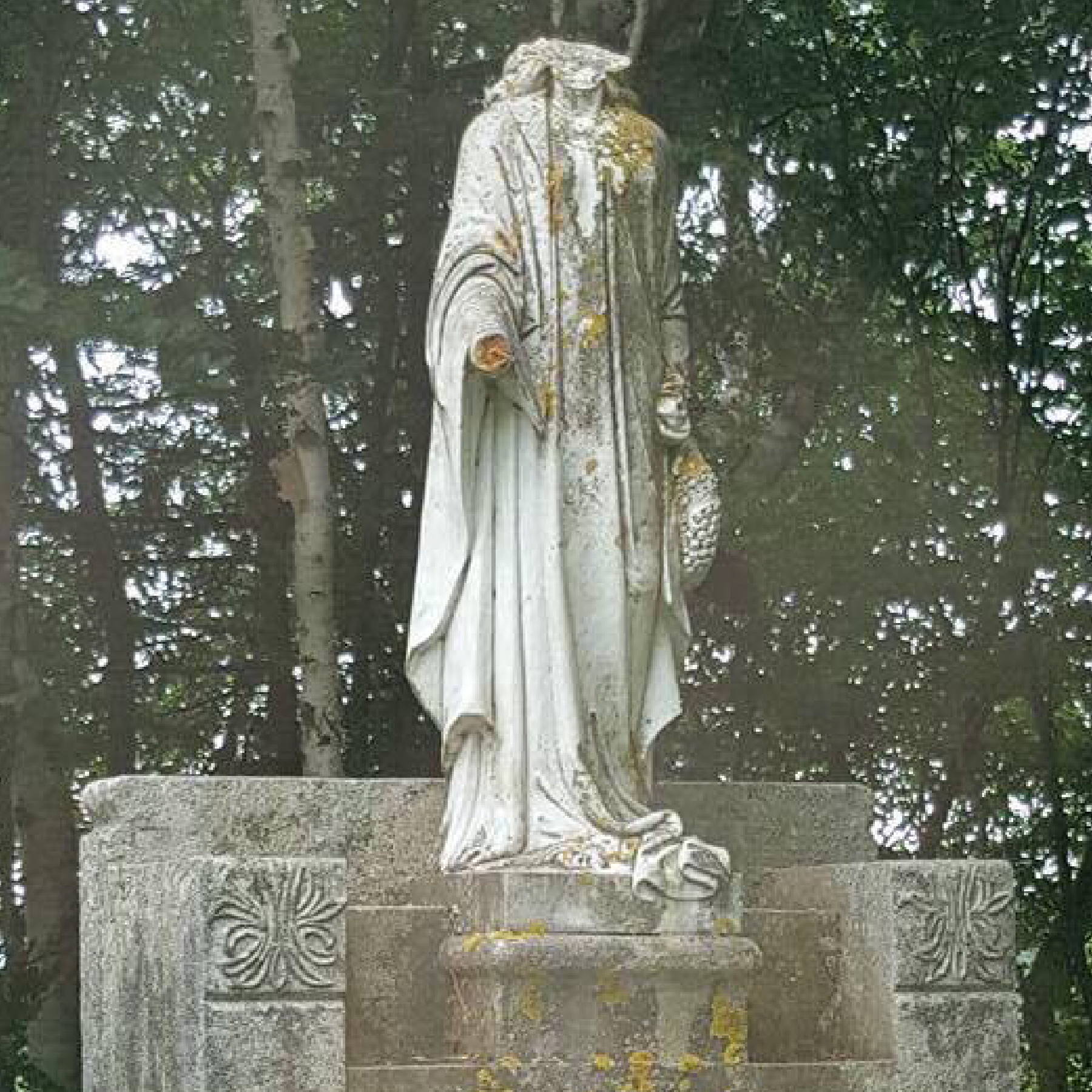 a statue of a person in a cemetery