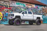 White lifted Silverado 2500HD at graffiti wall thumbnail