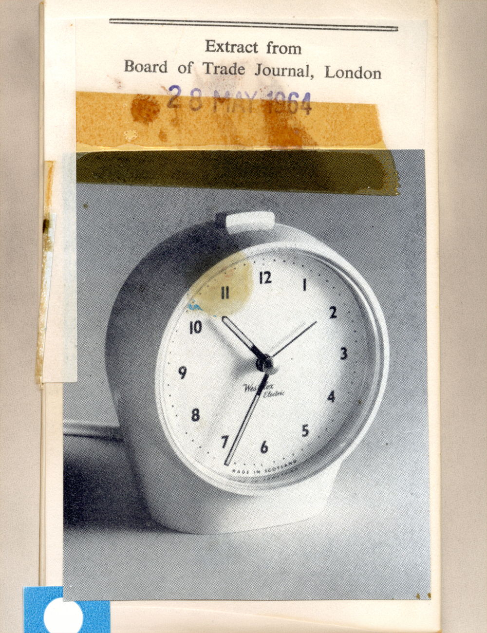 White round clock with black numbers on a page from a journal.