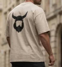Man wearing a beige t-shirt with a black beard logo on the back.