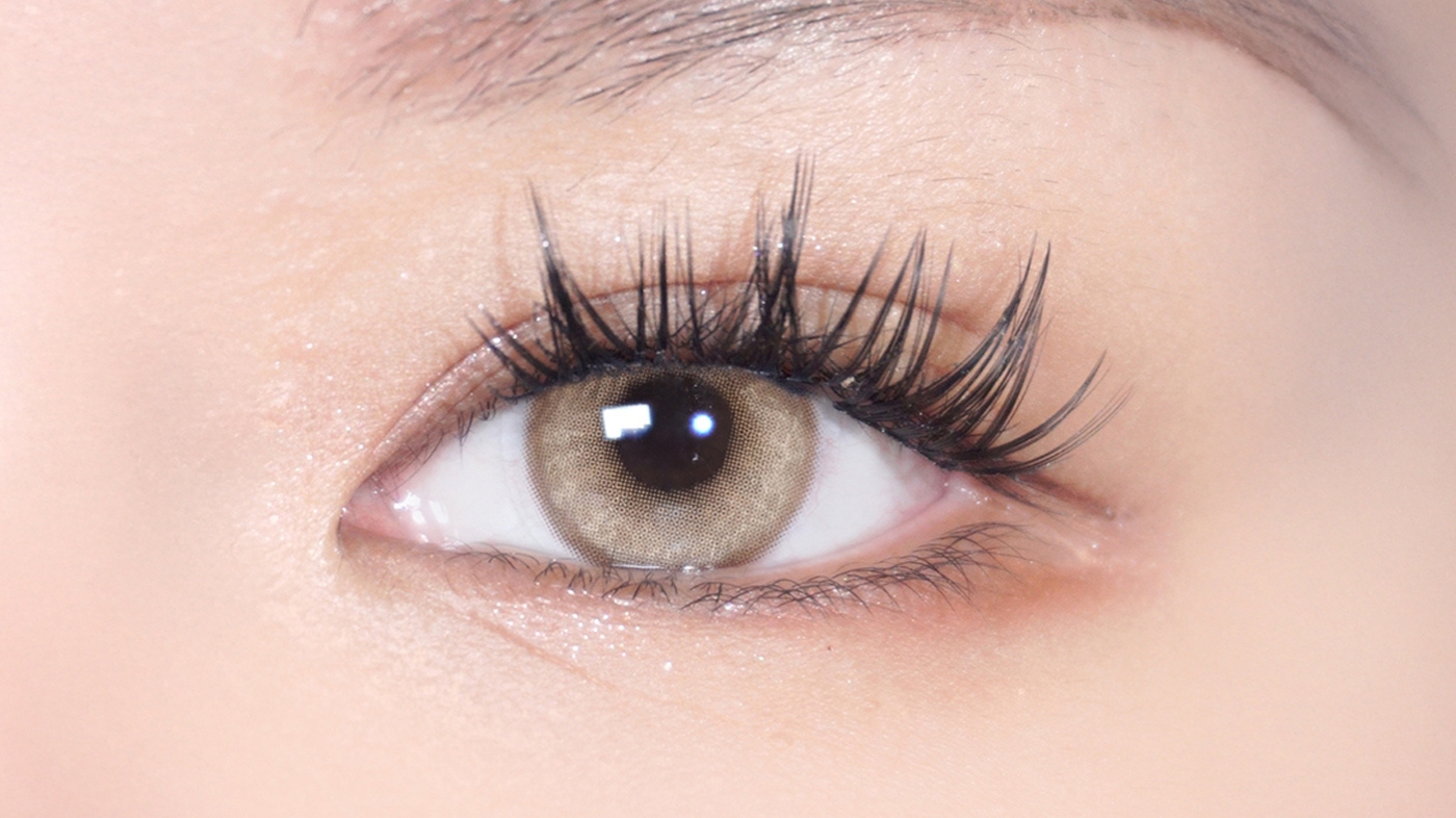 EyeCandys warm honey-brown circle contact lens close-up for Suma Demon Slayer cosplay — wide-eyed anime effect