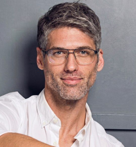 Man with grey hair wearing Euphoria rectangle glasses