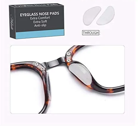 A picture of the self adhesive nose pads for eyeglasses placed on tortoiseshell acetate glasses