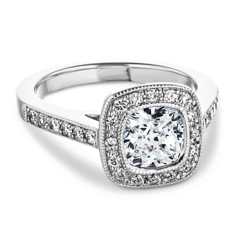 antique vintage engagement ring Shown with a 1.0ct Cushion cut Lab-Grown Diamond with a diamond accented and filigree detailed halo and accenting diamonds on the band in recycled 14K white gold