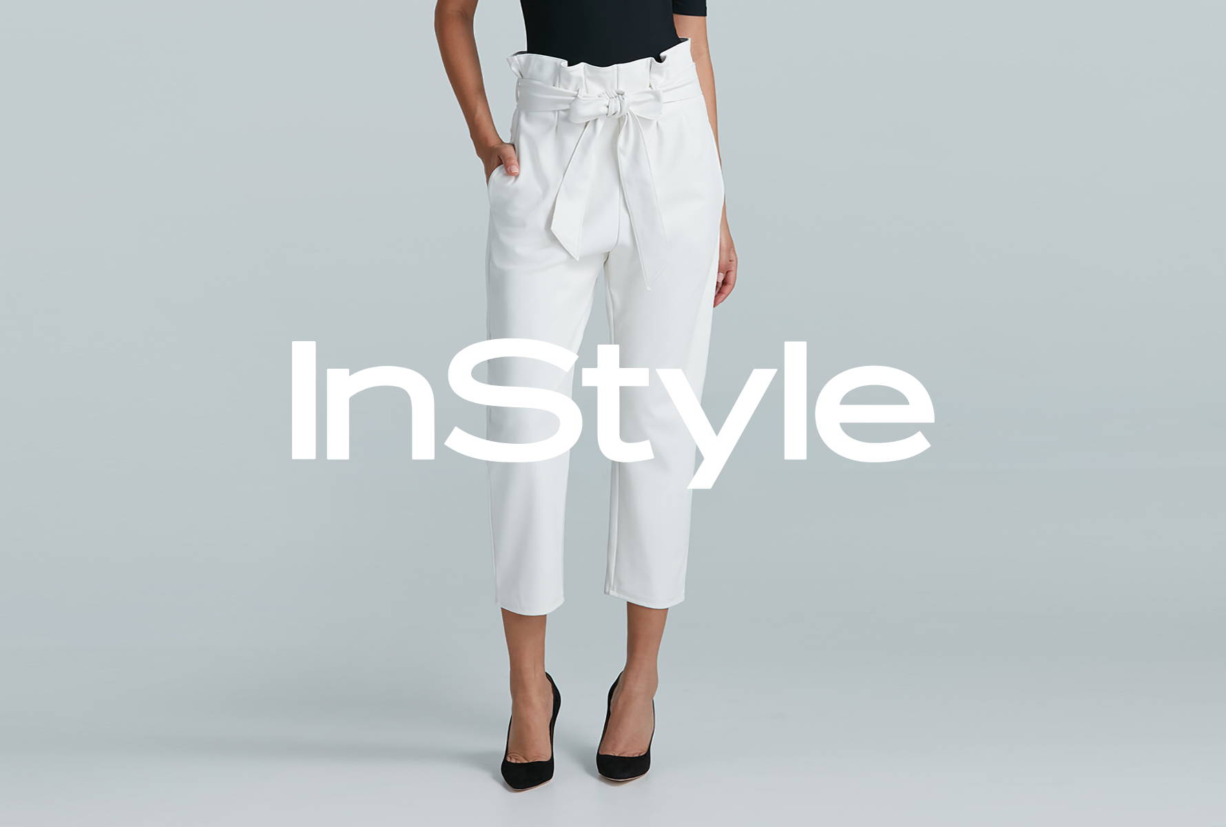 Model wearing the Faux Leather Paper Bag Pant in white with the InStyle logo overlayed ontop of the image.