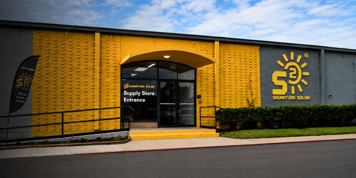 Signature Solar Sulphur Springs retail store building entrance with yellow accents and signage.