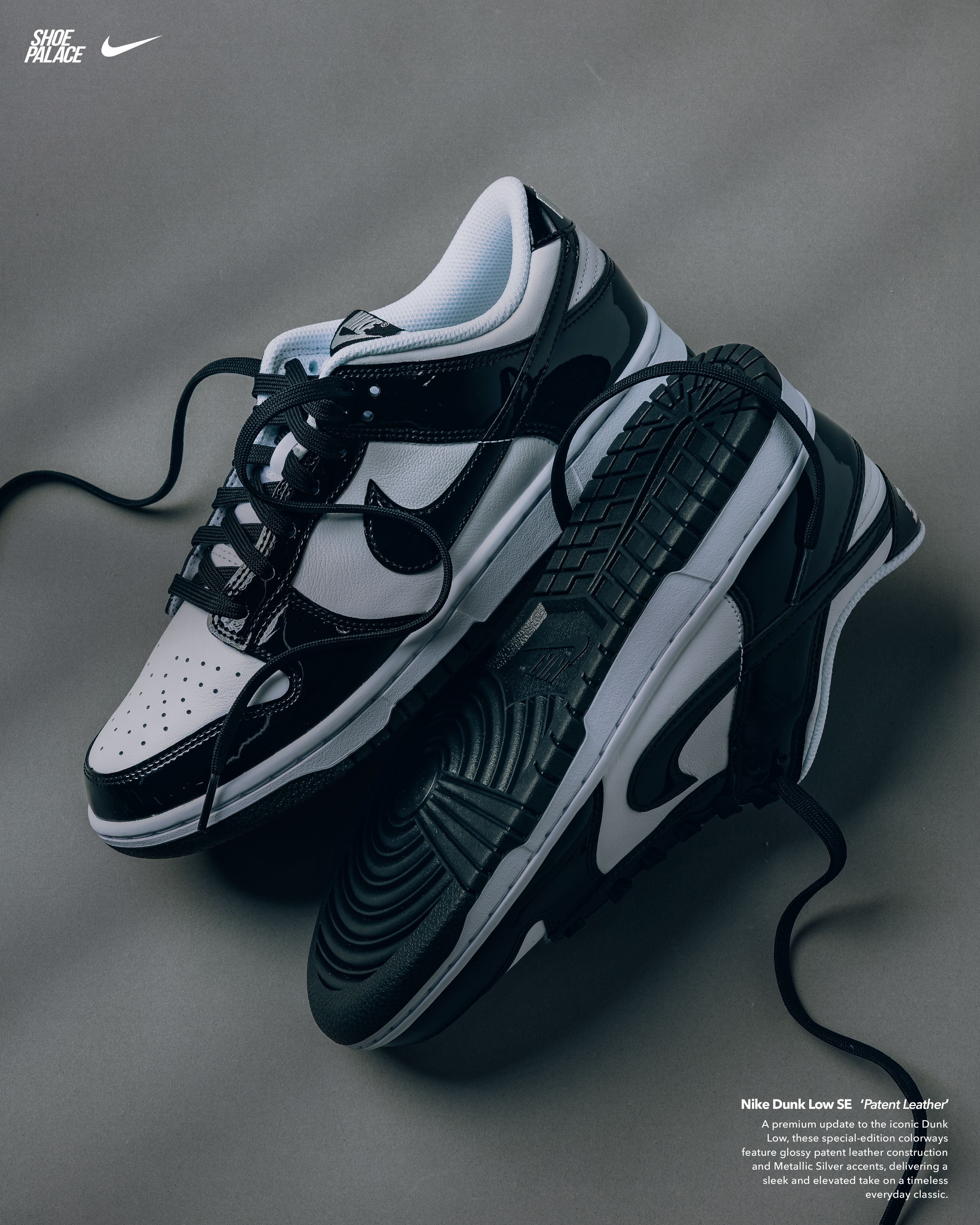 Black and white Nike sneakers displayed on a gray surface.