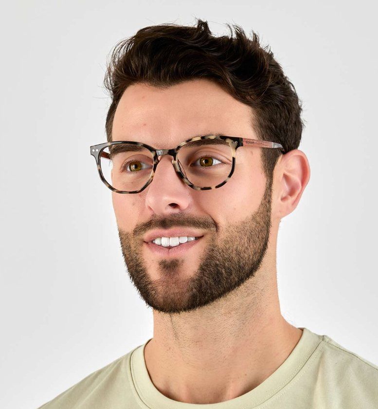 man with oval face wearing Faith Ivory, geometric tortoise glasses, on a white background