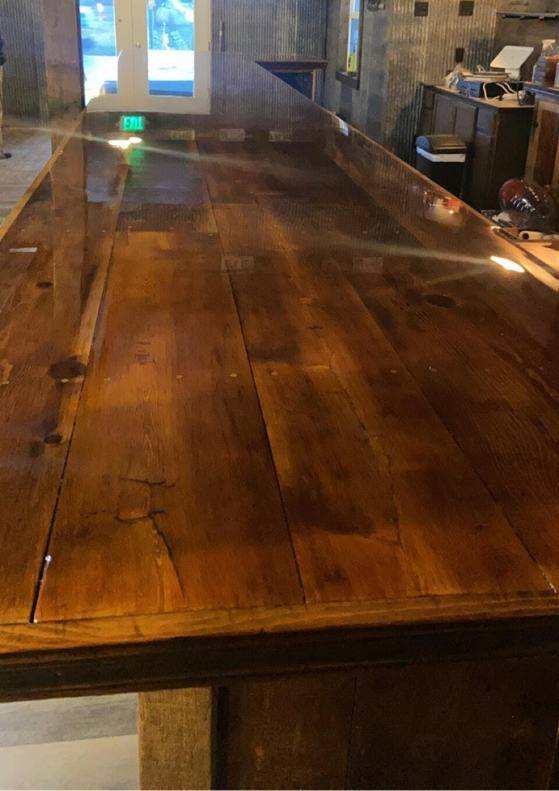 A long wooden epoxy bar top featuring a coating of UltraClear Epoxy.