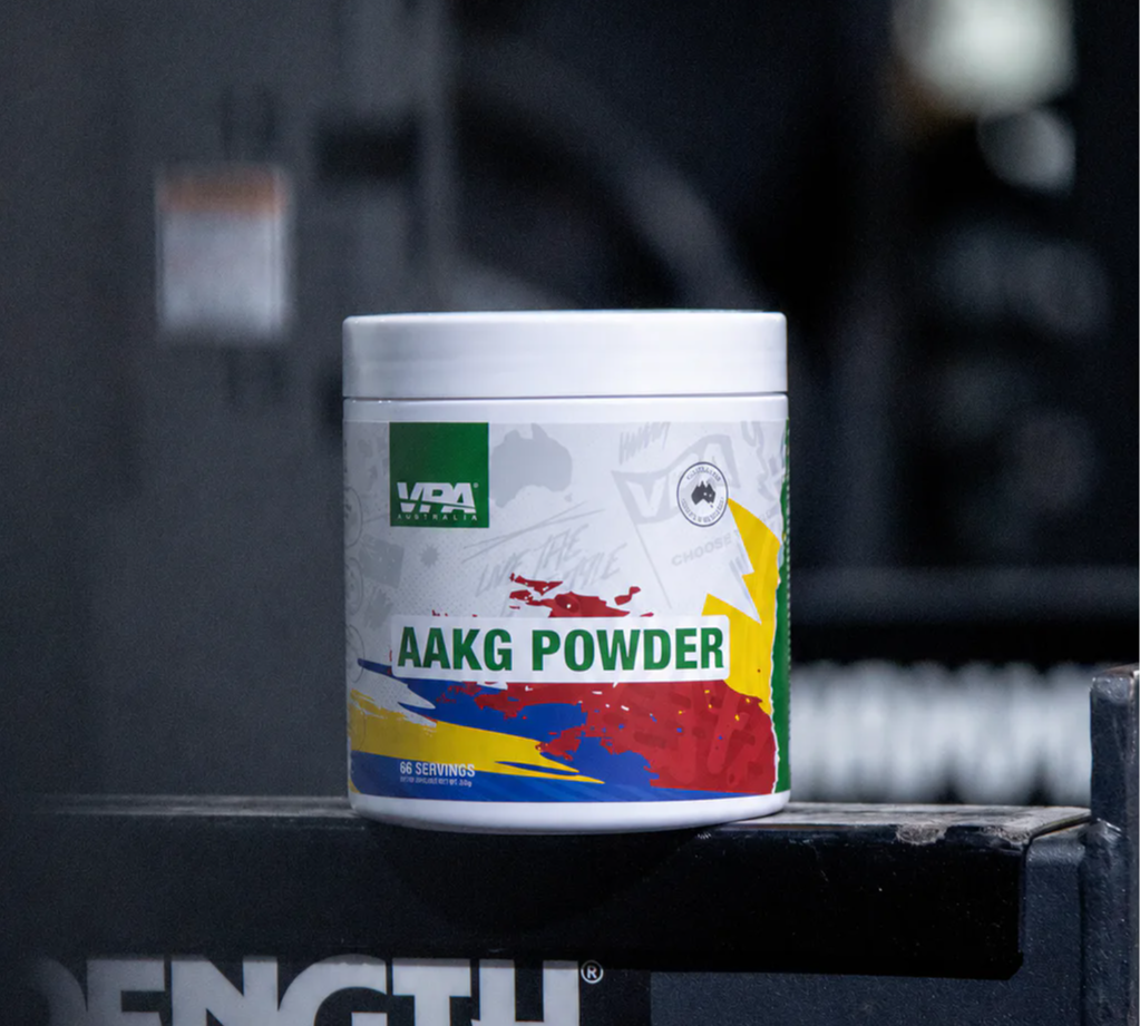 Container of AAKG powder on a gym equipment labeled 