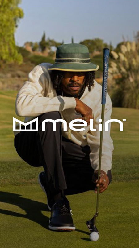 Person crouching on a golf course, preparing to putt a golf ball.