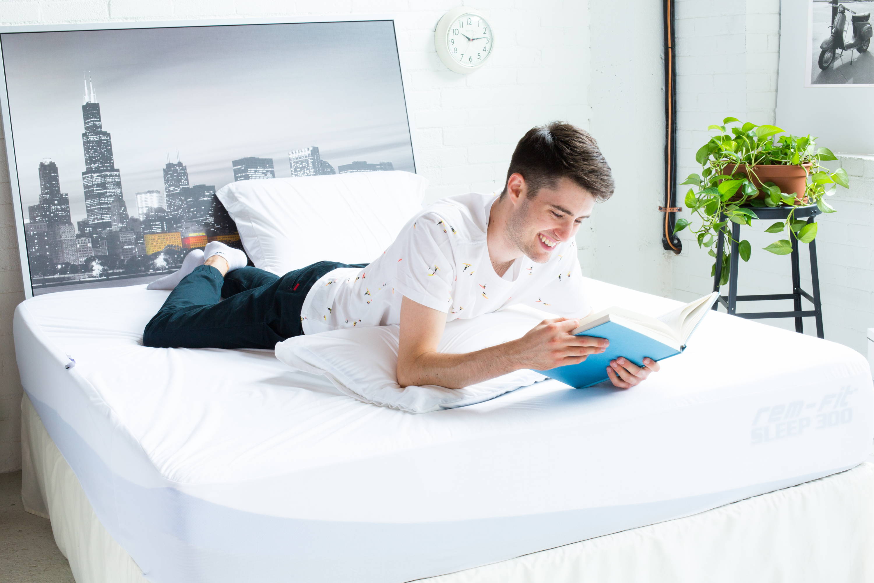 What Type of Mattress is Best for Me?. man reading book on stomach on advanced memory mattress