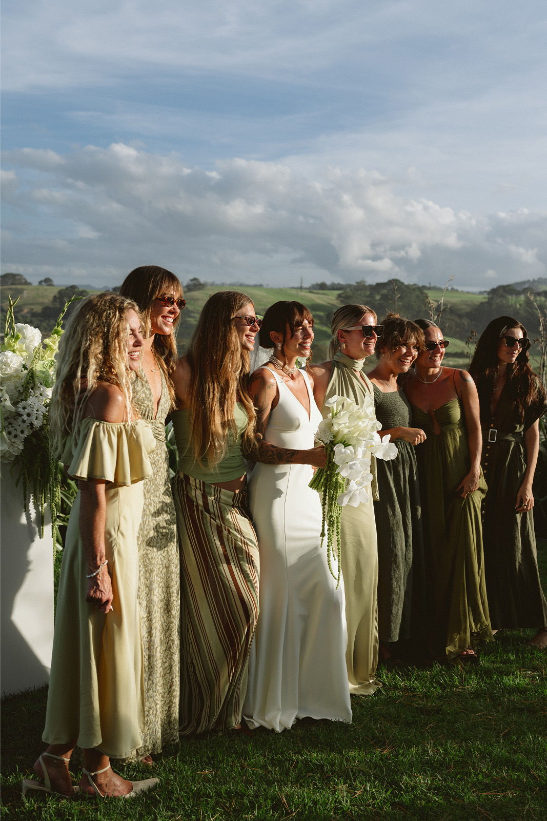 A group of women in dresses at an outdoor event.