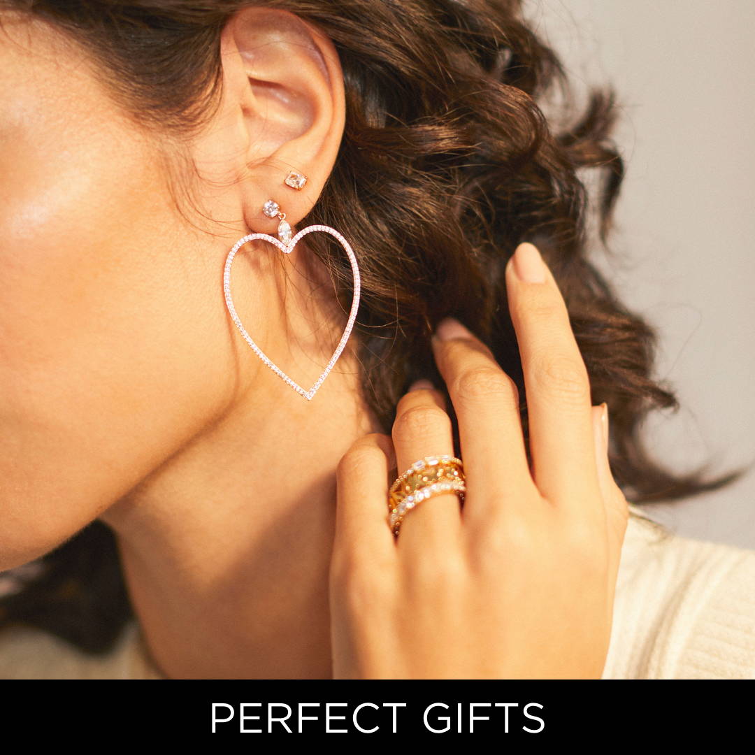SHOP PERFECT GIFTS (IMAGE OF MODEL WEARING LARGE PAVE CZ HEART EARRING AND STACKED CZ RINGS)
