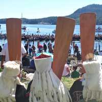 An Indigenous Event taking place at the water with boats and paddles