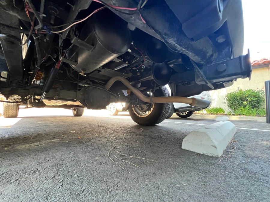 Rear undercarriage black air tank and train horns mounted on Jonathan's GMC Sierra frame photo 3