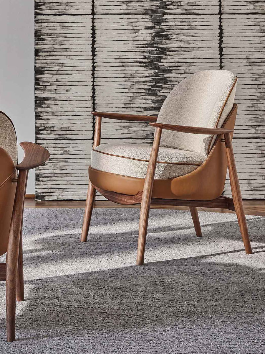 Ginkgo Armchair by Porada with wooden frame and beige upholstery and leather finish, in a stylish interior setting.