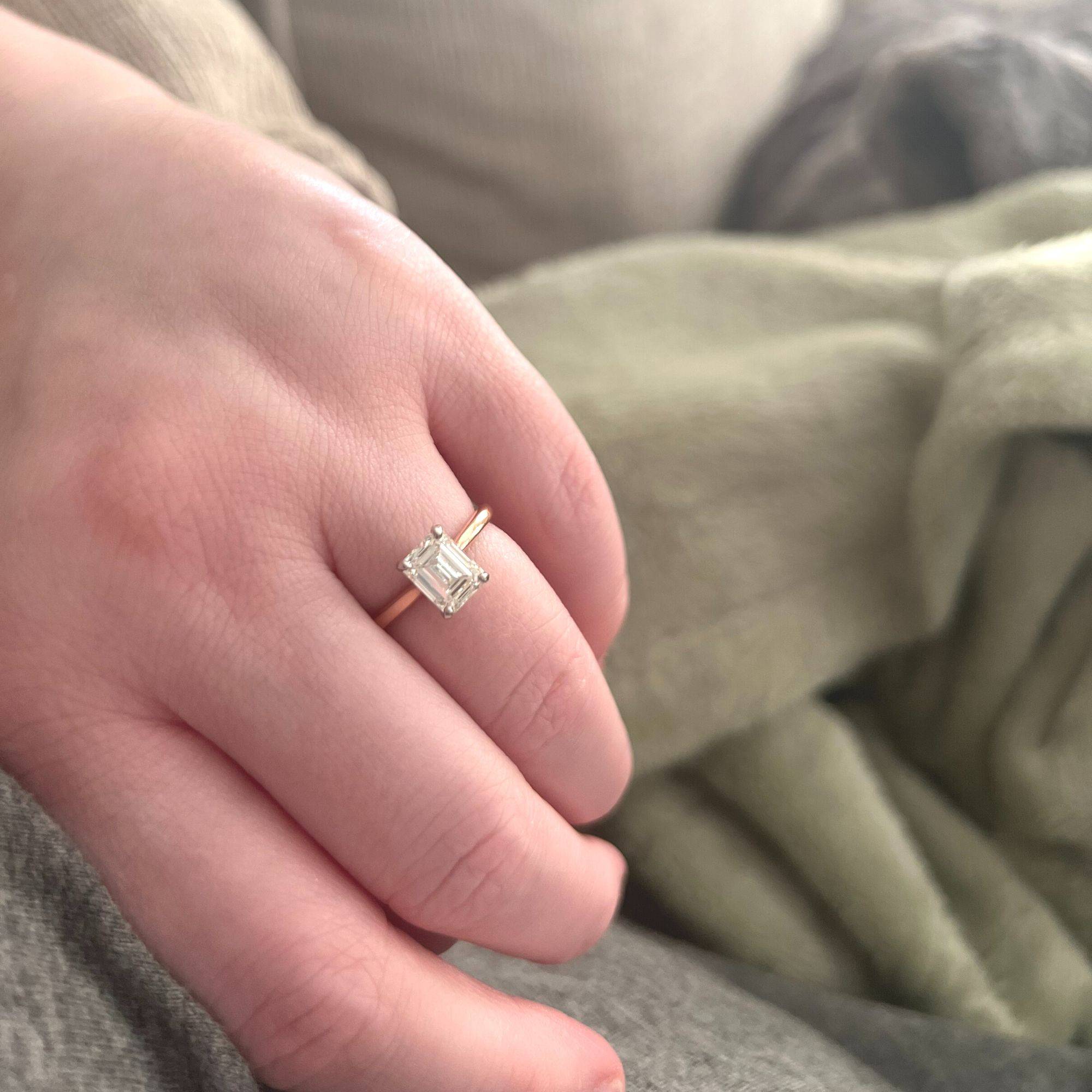 14k rose gold solitaire engagement ring with an emerald-cut diamond