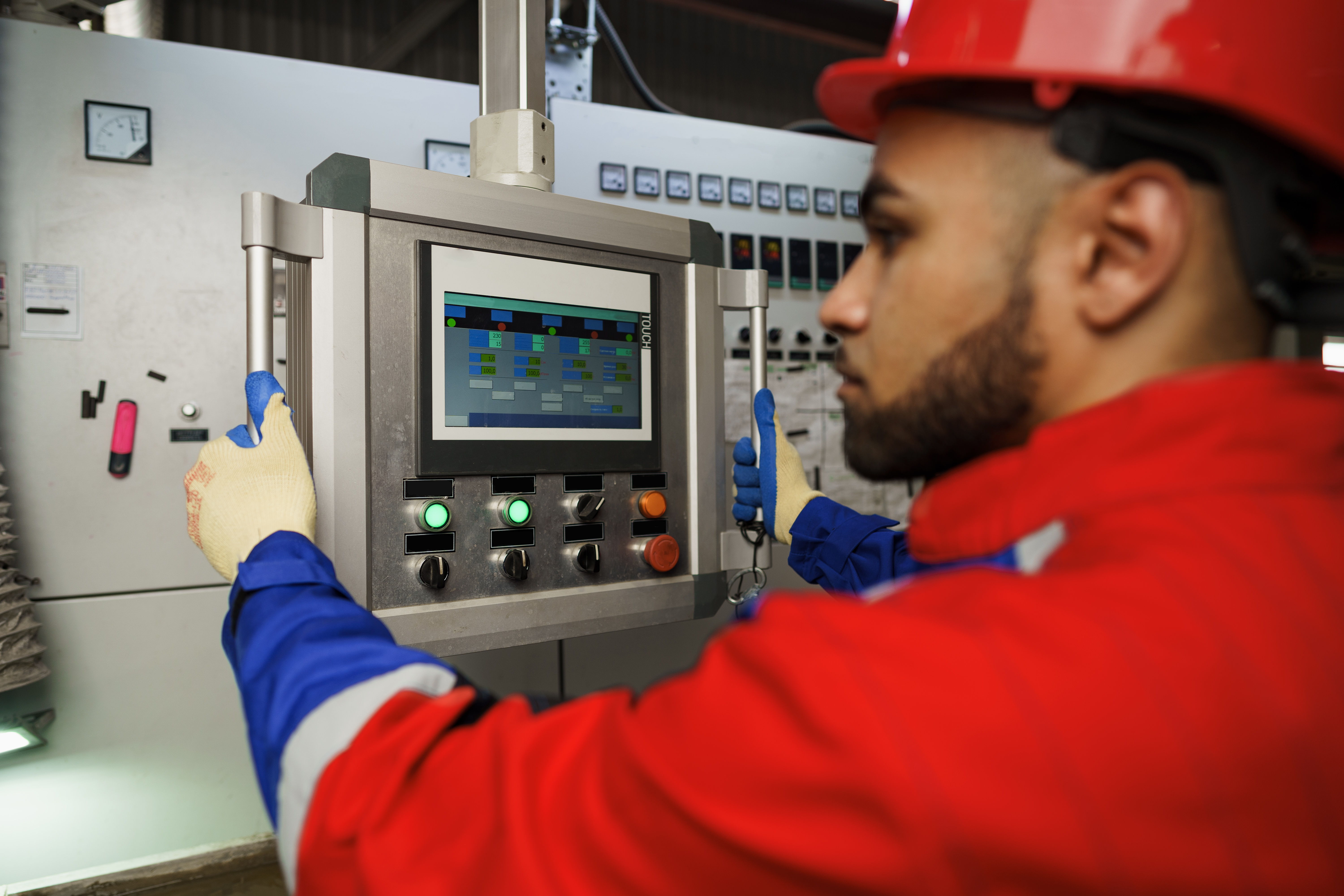 Factory worker utilizing a control panto operate machinery