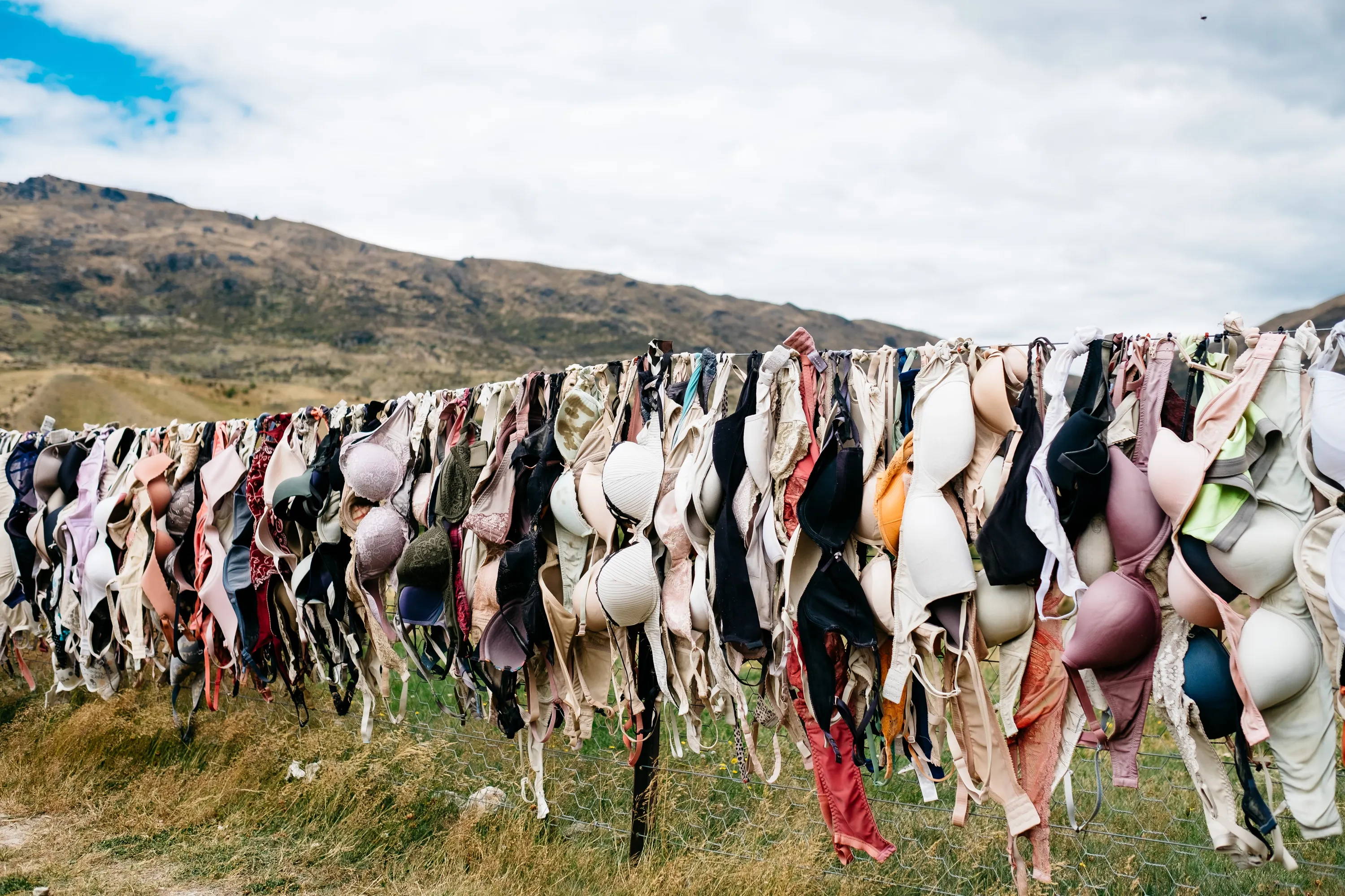 many bras hanging outside from clothesline