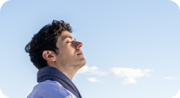 picture of a man with a ncie blue sky breathing calmly