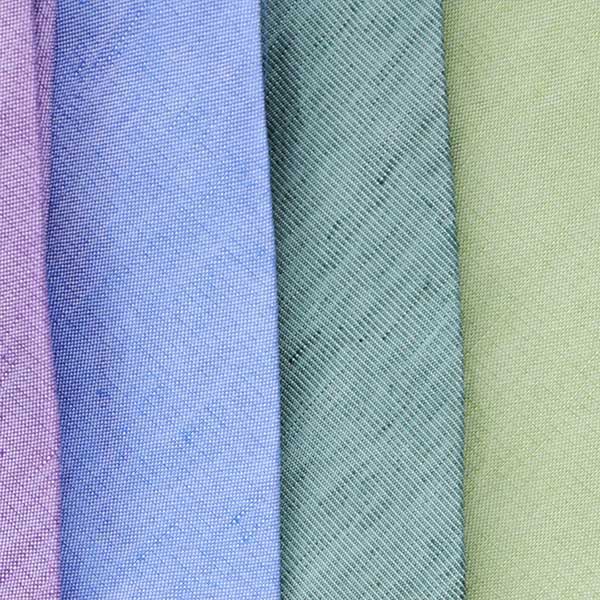 Close up of a linen summer ties, including sage, eucalyptus and cornflower