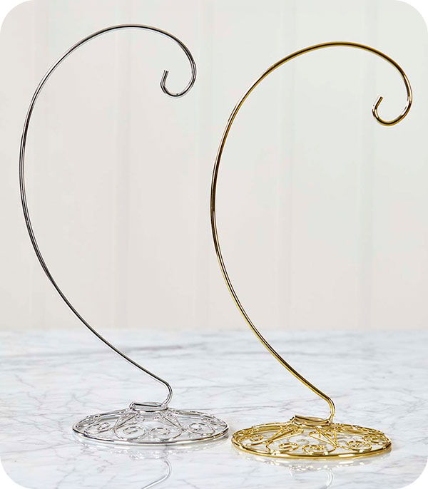 Two decorative metal stands in silver and gold colors.