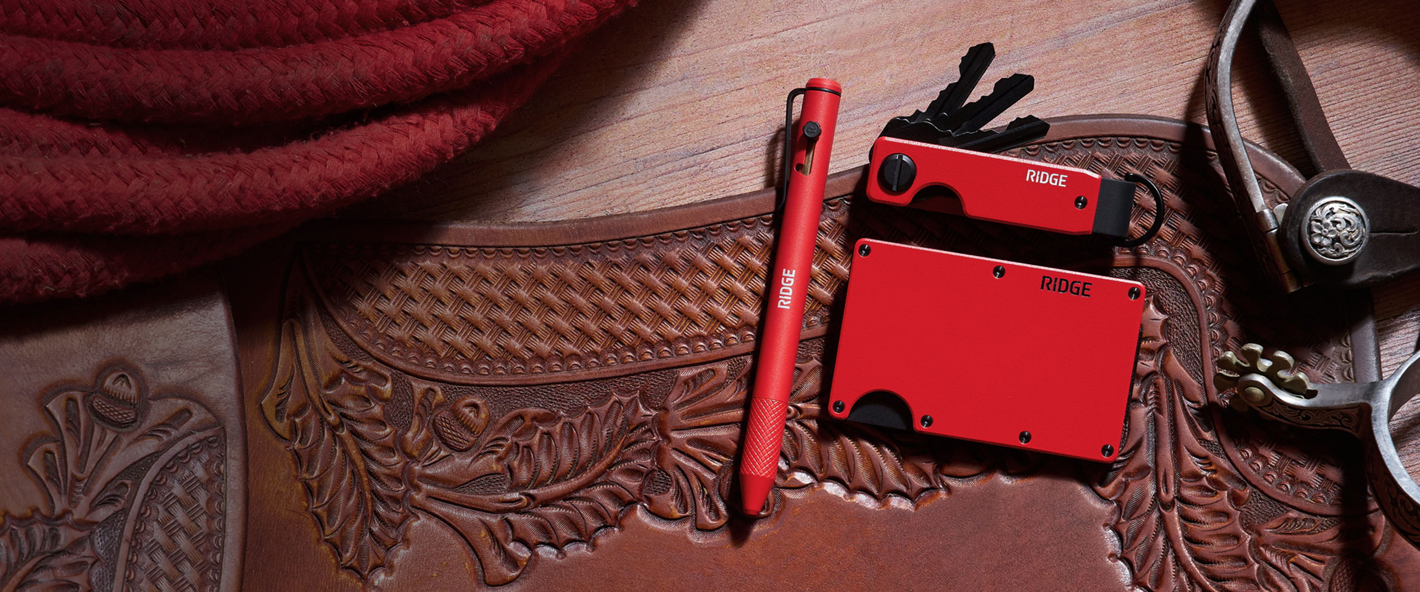 Red pen, wallet, and gloves on a textured surface.