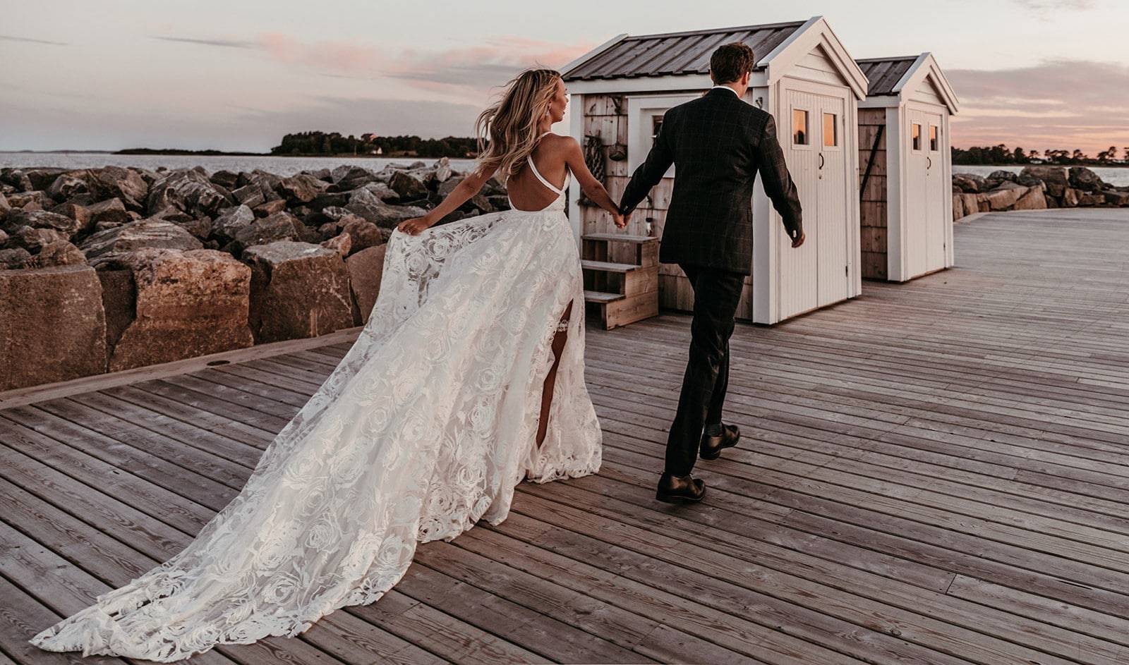 Grace Loves Lace bride wearing the Megan wedding dress on a pier with her new husband 