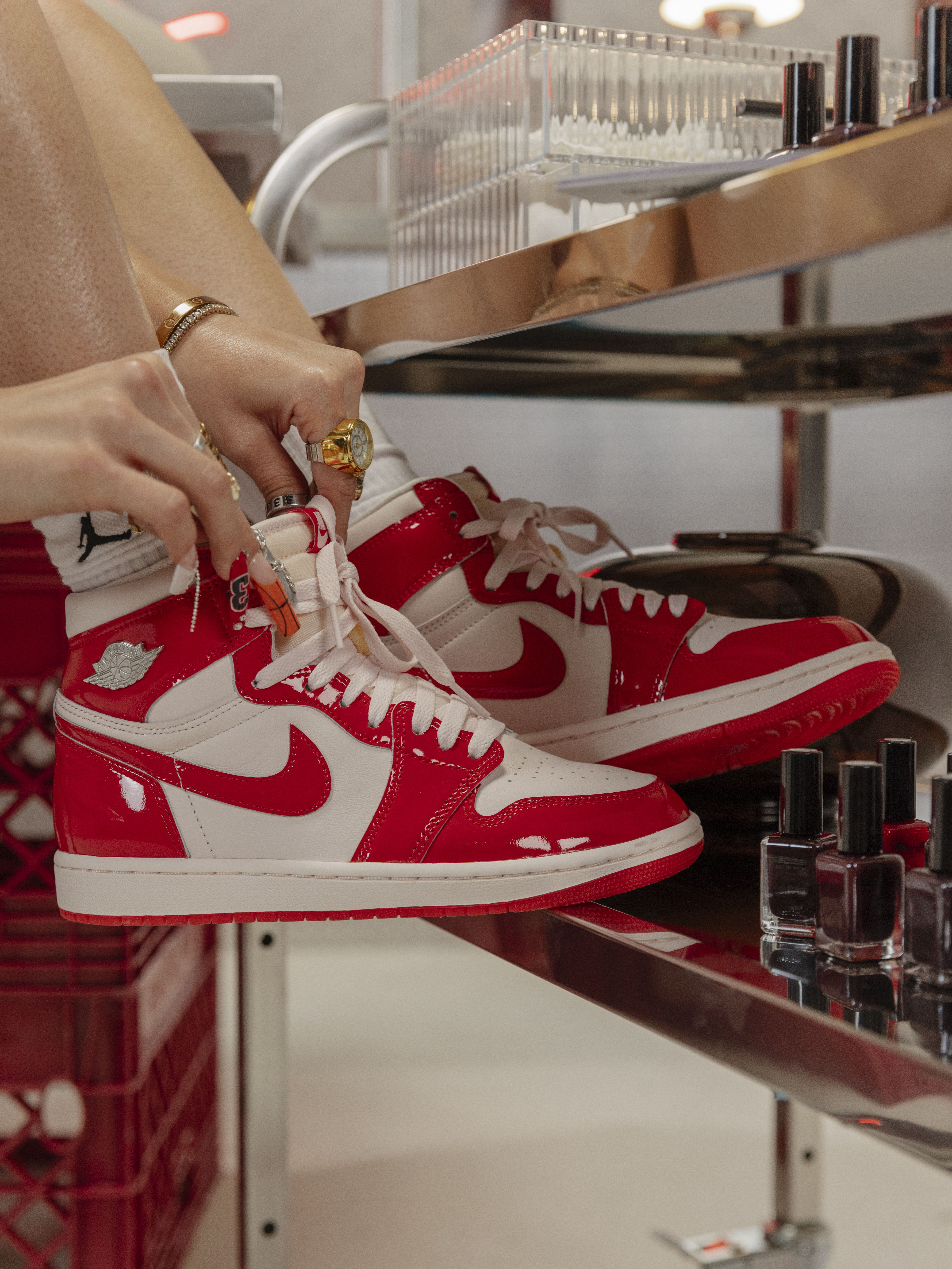 A close-up of red and white Nike sneakers on a shelf.