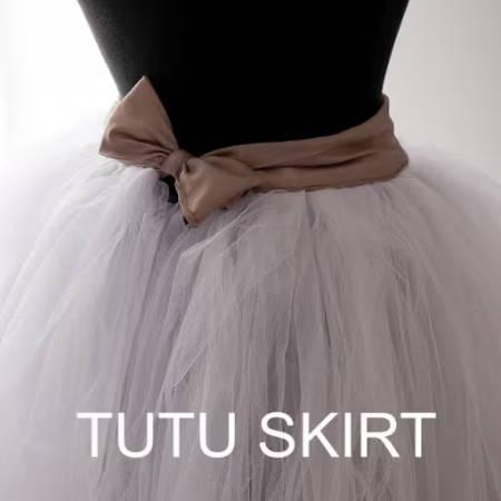 White handmade tutu skirt made out of tule with a brown satin waistband on a mannequin